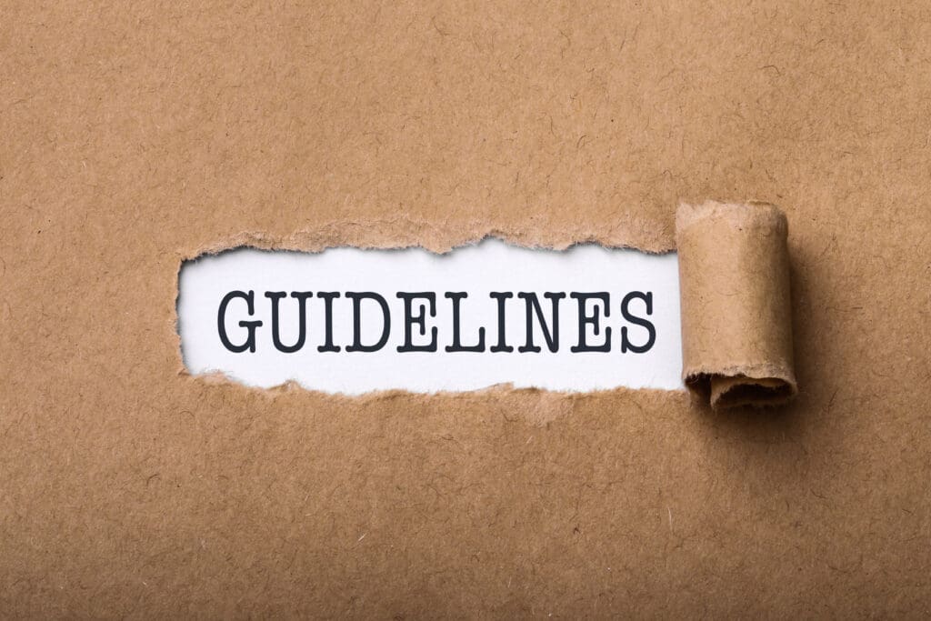 Decorative image for YouTube Community Guidelines. A brown paper fills the frame. It has been ripped in the center to reveal the word "GUIDELINES" below.