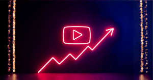 YouTube channel refresh 2026: A neon YouTube play button on a dark stage with a neon growth line moving up and to the right